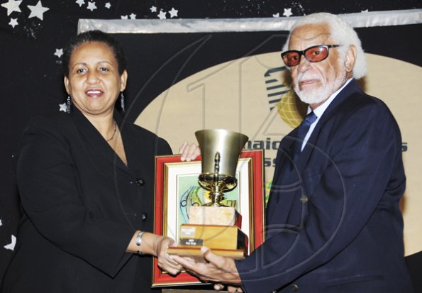 Winston Sill / Freelance Photographer
Jamaica Exporters Association (JEA) Awards Banquet, held at the Wyndham Hotel on Wednesday  night June 29, 2011. Here Winston Stona (right) presents the Model Exporter Trophy to Greta Bogues (left), of J Wray and Nephew.