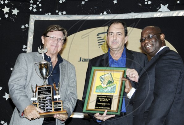 Winston Sill / Freelance Photographer
Jamaica  Exporters Assocaition (JEA) Awards Banquet, held at the Wyndham Hotel  on Wednesday night June 29, 2011. Here Vitus Evans (right) presents the runner-up to the Champion Exporters Trophy to Ian Garbutt (left), Managing Director, and Chris Boorman (centre), Director,  of Associated Manufacturing Company Limited.