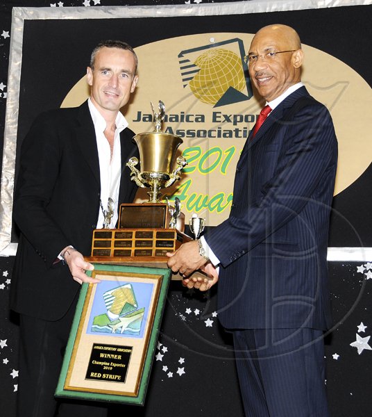 Winston Sill / Freelance Photographer
Jamaica Exporters Association (JEA) Awards Banquet, held  at the Wyndham Hotel  on  Wednesday night June 29, 2011.h Here Governor General Sir Patrick Allen (right) presents the Champion Exporter Trophy to Allan Barnes (left),  outgoing Managing Director of Red Stripe.