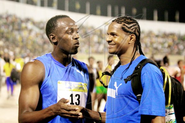 Anthony Minott/Freelance Photographer
Triple World record holder Usain Bolt (left), is congratulated by Jamaica's Germaine Gonzales, after bolt set a meet record of 19.56 secods in the men's 200m during the Jamaica National International Invitational athletics meet at the National Stadium, Kingston, on Saturday, May 1, 2010