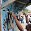 Ricardo Makyn/Staff Photographer.
These people do Labour Day work on this shop  in Riversdale, St Catherine yesterday.
