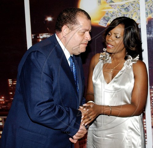 Winston Sill / Freelance Photographer
Finance and Planning Minister Audley Shaw, gets a word from the lovely  Belinda Williams of the National Commercial Bank at the Supreme Ventures Limited launch party for the "Super Lotto Game", held at Pure Plush Lounge, Trinidad Terrace, New Kingston on Tuesday.

***************************************************************************** August 25, 2009. here are Audley Shaw (left); and Belinda Williams (right).