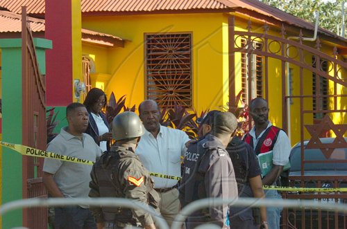 Rudolph Brown/Chief Photographer
Police officers at Luciana House after a two hour shoot out at the artiste's home with a lone gunman, three policemen were shot and injured at Westminster Crescent in St. Andrew on Wednesday, March 25-2009