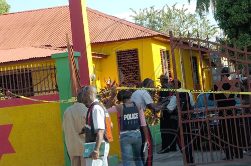 Rudolph Brown/Chief Photographer
Police officers at Luciana House after a two hour shoot out at the artiste's home with a lone gunman, three policemen were shot and injured at Westminster Crescent in St. Andrew on Wednesday, March 25-2009