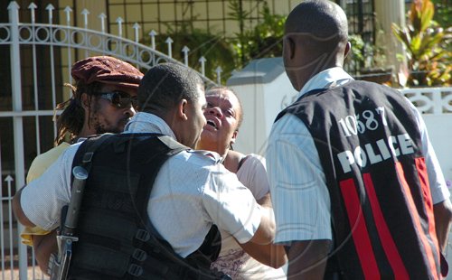 Rudolph Brown/Chief Photographer
One of Luciana baby mother crying for her daughter after a two hour shoot out at the artiste's home with a lone gunman, three policemen were shot and injured at Westminster Crescent in St. Andrew on Wednesday, March 25-2009