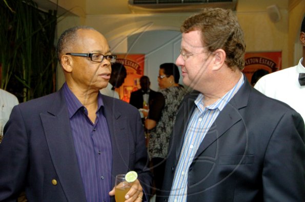 Winston Sill / Freelance Photographer
Alva Anderson (left) 'reasons' with Appleton Estate's Paul Henriques.
 Appleton Estate host Dinner and Tasting of Luxury Rum, held at Terra Nova All-Suite Hotel, Waterloo Road on thursday night November 19, 2009.