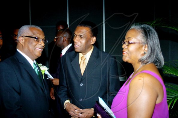 Winston Sill / Freelance Photographer
Businessman Glen Christian (left), has the attention of his wife Marva and  W. Billy Heaven, president of the  Mico University Alumni Association (MOSA).

******************************************************************* presents the Biennial Gold Medal Awards Banquet, held at the Jamaica Pegasus Hotel, New Kingston on Saturday night April 17, 2010.
