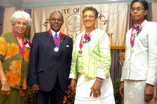 Peta-Gaye Clachar/Freelance Photographer
Musgrave sliver medal awardees (from left to right) Mrs. Jean Smith who was awarded for her contribution to Arts Administration, Professor Gossett Oliver for Engineering, Mrs. Paulette Bellamy for her contribution to music, and Professor Helen Jacobs for her contribution to Organic Chemistry shares a kodak moment at the Institute of Jamaica (IOJ) Musgrave Awards ceremony at IOJ on Wednesday, October 14, 2009.