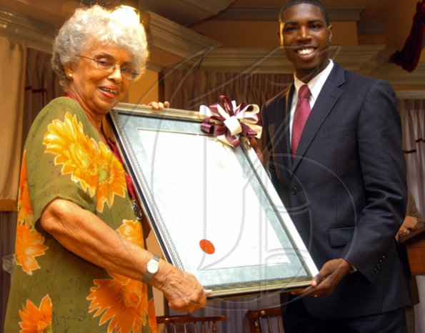Peta-Gaye Clachar/Freelance Photographer
Senator Warren Newby representing the Minister of Youth, Sports and Culture Honourable Olivia Babsy Grange presents Mrs. Jean Smith with a silver medal and citation for her contribution to Arts Administration at the Institute of Jamaica (IOJ) Musgrave Awards ceremony at IOJ on Wednesday, October 14, 2009.