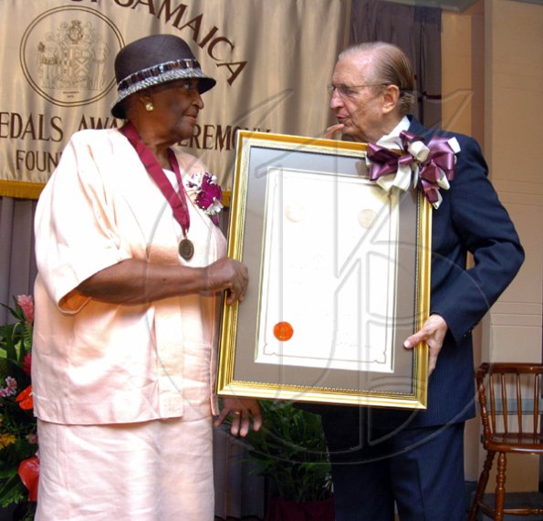 Peta-Gaye Clachar/Freelance Photographer
The Most honourable Edward Seaga presents Mrs. Rhona Welsh with a bronze medal and citation for her contribution to needlecraft at the Institute of Jamaica (IOJ) Musgrave Awards ceremony at IOJ on Wednesday, October 14, 2009.