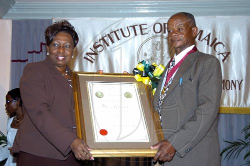 Peta-Gaye Clachar/Staff Photographer
Minister Youth Sports and Culture Olivia 'Babsy' Grange present a citation after presenting the Musgrave Gold Medal to Colonel Sidney Peddi  for his contribution to the Maroons at the Institute of Jamaica Musgrave Medals Awards Ceremony at the Institute of Jamaica on Thursday, May 28, 2009.