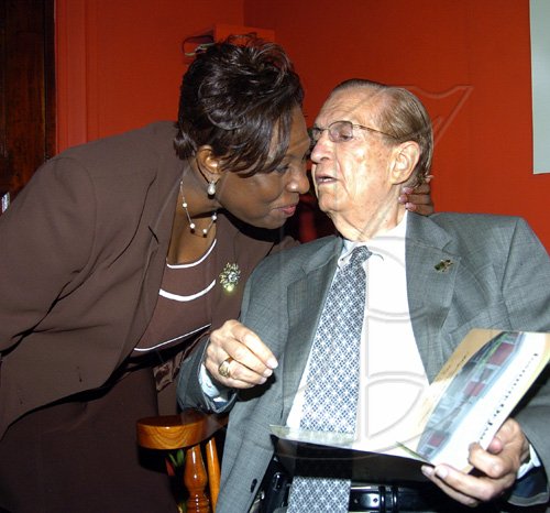 Peta-Gaye Clachar/Staff Photographer
Minister of Youth and Culture Olivia 'Babsy' Grange (left) gives a birthday kiss to former Prime Minister of Jamaica  the Right Honourable Edward Seaga celebrating his 79th birthday when he attended the Institute of Jamaice Musgrave Medals Awards Ceremony at the Institute of Jamaica on Thursday, May 28, 2009.