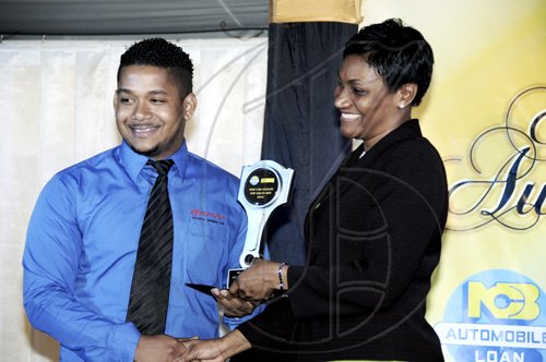 Winston Sill / Freelance Photographer
Kevin Jackson of Toyota Jamaica takes the New Car Sales Representative 2009/2010. Here he is presented with it by Audrey Tugwell-Henry.

National Commercial Bank (NCB) Auto Dealers Awards Ceremony, held at Terra Nova All-Suite Hotel, Waterloo Road on Tuesday night April 5, 2011.
