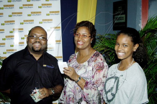 Winston Sill / Freelance Photographer
NCB Capital Market vice president of Investments, Vernon James (left) have a chat with colleague, Ann-Marie Hamilton (centre) and her daughter, Brooke Harrison before the Michael Jackson's movie. 



National Commercial Bank (NCB) host reception for Michael Jackson movie "This Is It", held at Carib Cinema, Cross Roads on Thursday October 29, 2009.