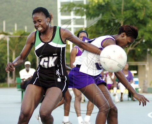 Peta-Gaye Clachar/Staff Photographer
Jamalco goalkeeper Nicole Aiken (left) and Walgrovians goalshooter Christina Salmon collide during game two of the JNA/Berger Paints netball final at the Leila Robinson courts yesterday.  Jamalco won 50-46 to tie the three-game series 1-1.