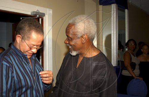 Winston Sill / Freelance Photographer
 Prime Minister Bruce Golding (left) may be getting some fashion tips from P.J. Patterson.

 for his Caricom Award, held at the Jamaica Pegasus Hotel, New Kingston on Monday July 27, 2009.