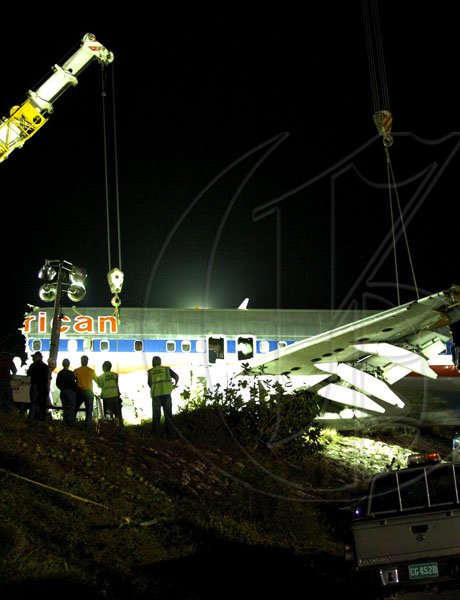 Winston Sill / Freelance Photographer
Removal of crash American Airlines aircraft from the crash site, off Port Royal Road, on Monday night December 28, 2009. Winston Sill / Freelance Photographer
Removal of the middle section of the  crashed  American Airlines aircraft from the crash site, off Port Royal Road, on Monday night December 28, 2009.