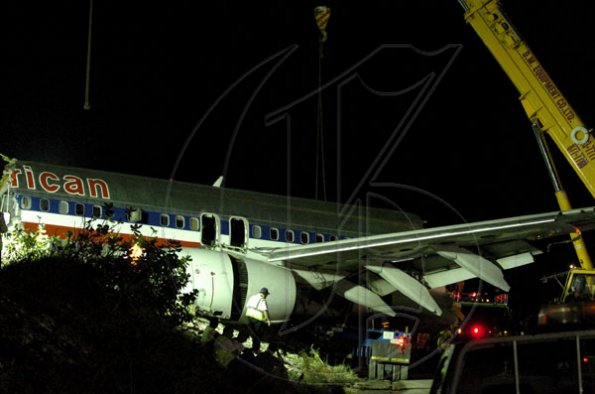 Winston Sill / Freelance Photographer
Removal of crash American Airlines aircraft from the crash site, off Port Royal Road, on Monday night December 28, 2009. Winston Sill / Freelance Photographer
Removal of the middle section of the  crashed  American Airlines aircraft from the crash site, off Port Royal Road, on Monday night December 28, 2009.