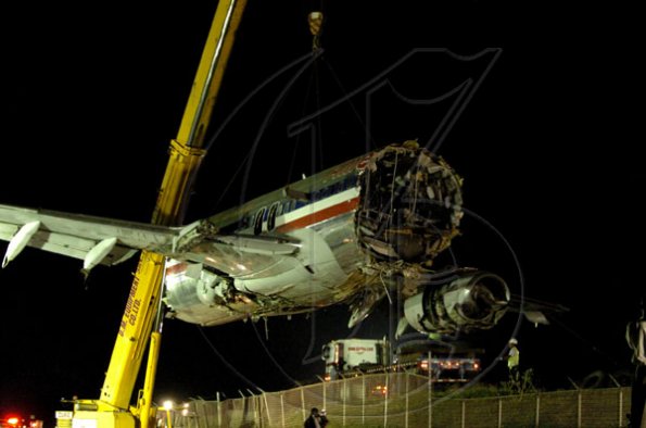 Winston Sill / Freelance Photographer
Removal of crash American Airlines aircraft from the crash site, off Port Royal Road, on Monday night December 28, 2009. Winston Sill / Freelance Photographer
Removal of the middle section of the  crashed  American Airlines aircraft from the crash site, off Port Royal Road, on Monday night December 28, 2009.
