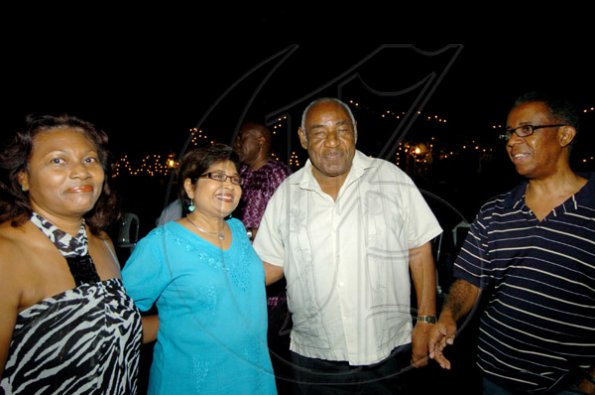 Winston Sill / Freelance Photographer
Between health services guru Lester Woolery (second right) and Road Safety boss Dr Lucien Jones (right) Linda Woolery (left) and Jean Lowrie-Chin have nothing to worry about.
PROComm Christmas Party, held at Kingsway on Saturday night December 5, 2009.