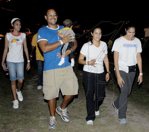 Colin Hamilton/ Freelance Photographer
The Gleaner's Deputy Managing Director Christopher Barnes (second left), carries son Adrian during laps with his wife Isabelle and friends at yesterday morning's Relay for Life.

**************************************************************************************************** on June 13