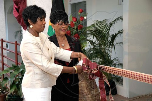Ian Allen/Staff Photographer
Juliet Lyn-Chuck (left) and her mother Sylvia Lyn cut theribbin to officially open the new wing at Hargreaves Memorial Hospital in Mandeville, Manchester on Thursday August 27.