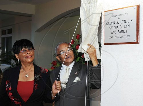 Ian Allen/Staff Photographer
Calvin and Sylvia Lyn enjoy the historic moment of unveiling the plaque that declares it all official. The  Hargreaves Memorial Hospital in Mandeville is now open for business!.