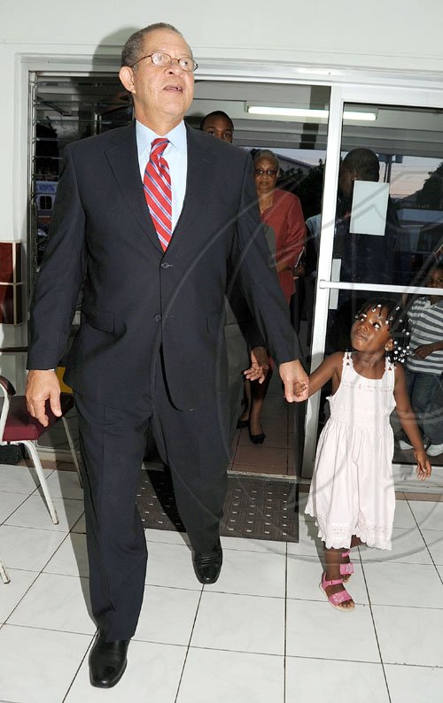 Ian Allen/Staff Photographer
Prime Minister Bruce Golding has a cute little  escort, Alia  Ann Tracey, daughter of popular sports commentator Oral Tracey, to accompany him as he tours the  Hargreaves Memorial Hospital in Mandeville.
