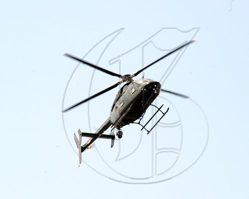 Norman Grindley /Chief Photographer
A Jamaica Defence Force helciopter hovers above West Kingston Mondayday, as gunmen and police trade bullets during an operation in the Hannah Town and Denham Town area.