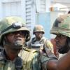 Norman Grindley/Chief Photographer
Soldiers discuss strategy during a three-hour gunfight in Hannah Town, west Kingston, on Monday. Three men were killed in the firefight and three policemen sustained gunshot injuries.


West Kingston riot, March, 15, 2010.