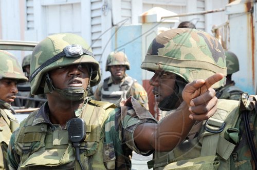 Norman Grindley/Chief Photographer
Soldiers discuss strategy during a three-hour gunfight in Hannah Town, west Kingston, on Monday. Three men were killed in the firefight and three policemen sustained gunshot injuries.


West Kingston riot, March, 15, 2010.
