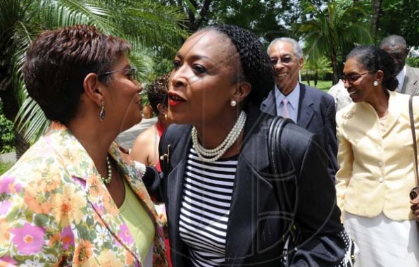 Rudolph Brown/Photographer
Yvonne Wilks, (centre) greets Dorraine Samuel-Binger, (left) and TVJ's Managing Director Kay Osborne at the RJR 60th Anniversary long service awards luncheon at the Terra Nova Hotel in Kingston on Friday, July 9-2010.