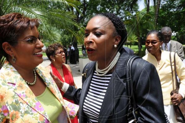 Rudolph Brown/Photographer
Yvonne Wilks, (centre) greets Dorraine Samuel-Binger, (left) and TVJ's Managing Director Kay Osborne at the RJR 60th Anniversary long service awards luncheon at the Terra Nova Hotel in Kingston on Friday, July 9-2010.