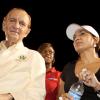 Contributed
Former Prime Minister Edward Seaga, gives us a quick smile before joining Flow president and COO Michelle English (right) and Public Relations Manager, Denise Williams, in presenting the big cheque to the Flow's Champion's Cup's winning team, Boy's Town.