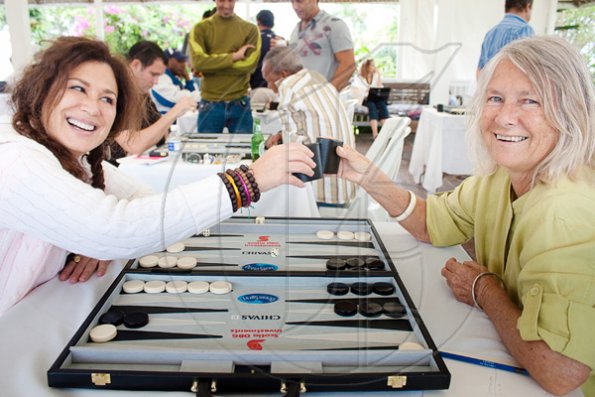 Contributed
1 Lisa Gabor (left) and Sally Henzell give a friendly toast of their dice cups before getting down to business at the 5th Annual Strawberry Hill 'High Stakes' Backgammon Tournament.