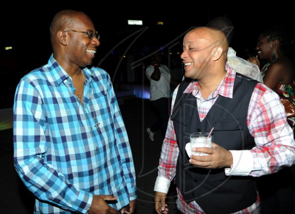 Rudolph Brown/Photographer
Mark Chisholm, (right) vice president, Individual Life Sales, Sagicor chat with Karl Williams, Vice President Human Resources at the Sagicor christmas party at the Office car park in New Kingston on Saturday, December 12-2009