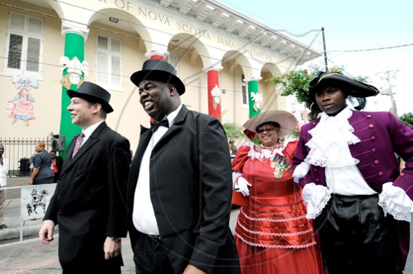 Rudolph Brown/Photographer
From left: Bruce Bowen, president and chief executive officer, Scotiabank Group Jamaica, Michael Shaw, Scotiabank King's Street branch manager, Joan Badson Mignott and Troy Laing, walk past the bank before the official opening  that marks the celebration of 120 years in Jamaica from 1889 to 2009 at the branch on on Monday, December 14.

*******************************************************************-2009