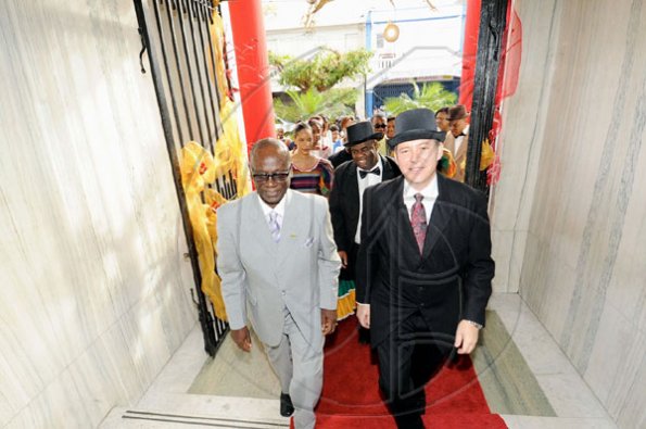 Rudolph Brown/Photographer
Mayor of Kingston Desmond McKenzie (left), Bruce Bowen (right), president and chief executive officer, Scotiabank Group Jamaica and Michael Shaw, (behind them),  Scotiabank King Street branch manager, enter the bank after the official opening during the bank's 120-years in Jamaica celebration last  Monday.

*********************************************************************************** from 1889 to 2009 at the Kings Street Branch on Monday, December 14-2009
