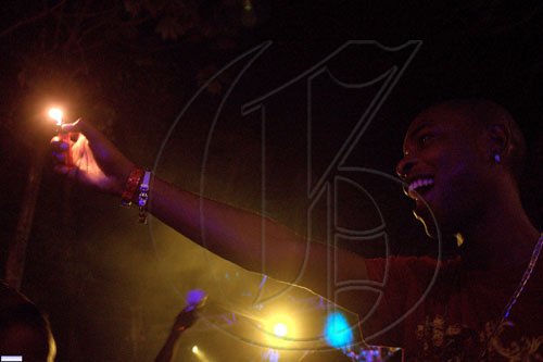 A satisfied patron raises a lighter in appreciation of DJ Mario C of 3rd Dimension, who played a well-received set at 'LUAU'.