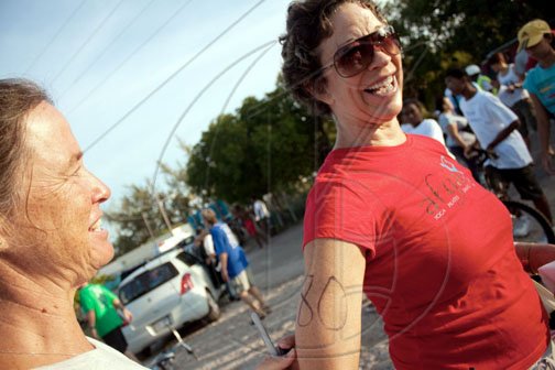 In the glow of the early morning sun, Sonita Morin Abrahams, owner and director of popular Kingston yoga studio Afya, is in cheerful spirits as she gets imprinted with her race number for her leg in the Jake's Off-Road Triathlon.