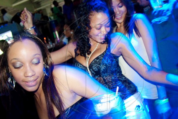 Bathed in electric blue from the overhead strobes, these ladies celebrate the return of 'The Fantastic Mega-Club YUSH' to the National Indoor Sports Centre last Saturday.