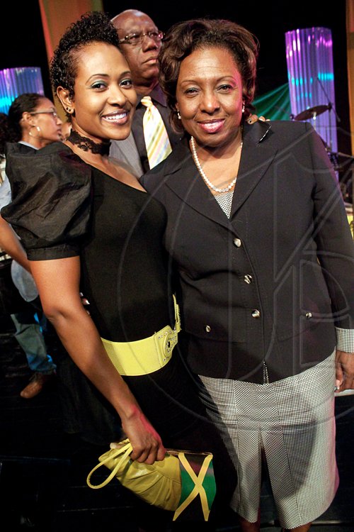 Allison Watson (left) shows off the perfect ensemble to heed Minister of Youth, Sport & Culture, Olivia 'Babsy' Grange's mandate to display our Jamaican pride by wearing the national colours during Jamaica Festival.
