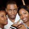 Joined by friends Shawnette Pike (left) and Shantell 'Shanz' Hill, marketing manager for Scikron/Bigyard Music, Sadieki Bolt cheers on big bro Usain, as he does his turn as a footballer at the Bob Marley One Love Charity Celebrity Football Matches and Celebolympics.