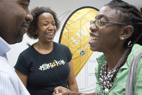 Recently returned from her landmark role as Jamaica's representative for the the Commonwealth Women's Antarctic Expedition, Kim-Marie Spence joins in a laugh at Kingston Beta with event host Ingrid Riley (centre) of internet marketing firm, Connectimass.