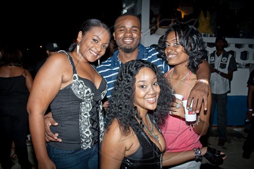 Equiknoxx music producer Derrick Coffie wasn't short of arm candy at 'Musique', surrounded by lovely ladies, (from left) Ayesha Dawes, Latifa 'Tifa' Brown and Crystal Gordon.