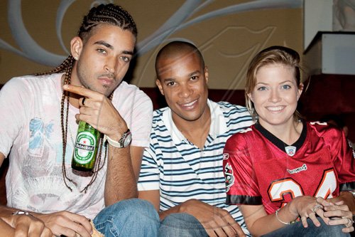 American football fans, Jordon McClure of Chimney Records, attorney Gary Harris, and UWI student Angelica Gordon, were glued to the flat screens of Fiction Lounge for the Fiction Superbowl Fiesta.