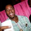 A grilled chicken kebab in one hand and a drink in the other, Foods-R-Us restauranteur Jermaine Everett works the dancefloor at SAKE.