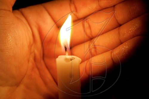 The "Walk for Haiti" culminated in a candle-lit vigil. Shielding his flame from the wind, Rotarian Garfield Wedderburn would later remark that this was "symbolic of life...sometimes you need a hand to keep your flame lit."