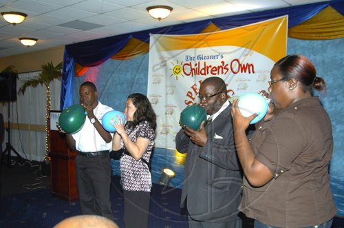 Winston Sill/Freelance Photographer
Enjoying the challenge of the 'balloon game' From left are Errol Campbell, St. Catherine coach, Susan Chang-Pong, director of Tastee's Ltd, Hanif Brown (Jr.) parent of 3rd place champion, and Deborah Thomas (sister of 2001) champion Daniel Thomas).