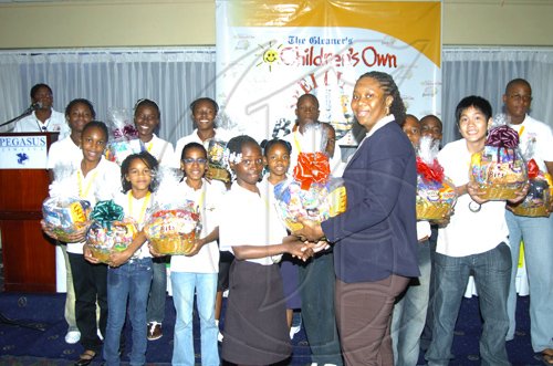 Winston Sill/Freelance Photographer
Tenesia Malcolm, gleaner's Children's Own Co-ordinator presents a gift basket on behalf of Continental Baking Company.